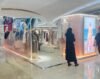 White bespoke clothing showcase installed in shopping mall concession booth