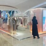 White bespoke clothing showcase installed in shopping mall concession booth